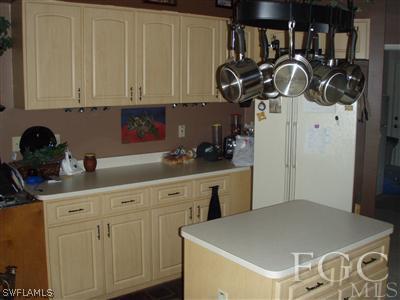 9167 Henry Road Fort Myers, FL 33967 - Photo 5 of 10 a kitchen with stainless steel appliances granite countertop a sink a stove and dishwasher