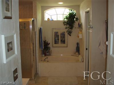 9167 Henry Road Fort Myers, FL 33967 - Photo 6 of 10 a bathroom with a tub and shower