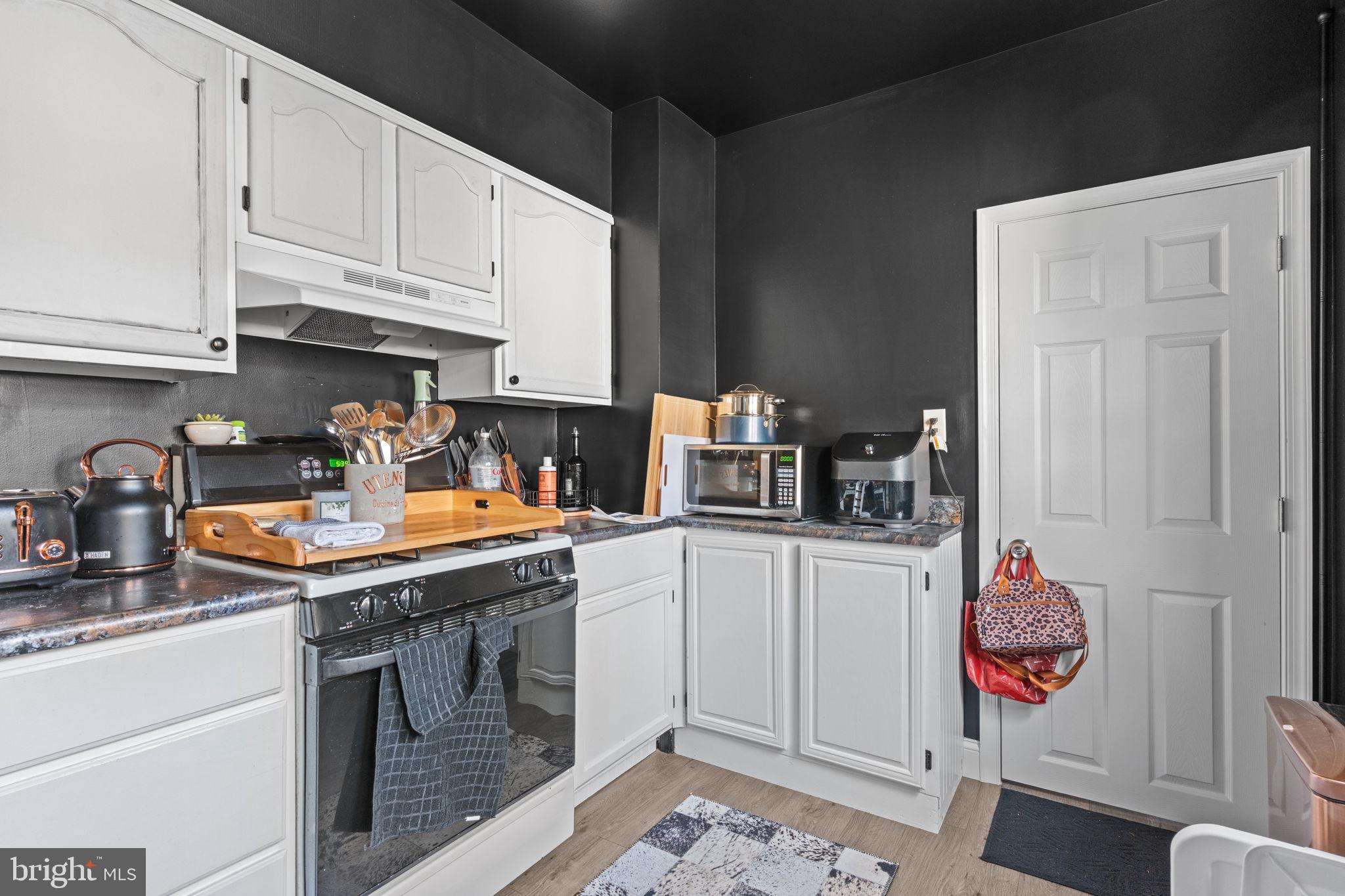 2114 Redwood Avenue Upper Chichester, PA 19061 - Photo 12 of 33 a kitchen with stainless steel appliances granite countertop a stove a sink and a white cabinets