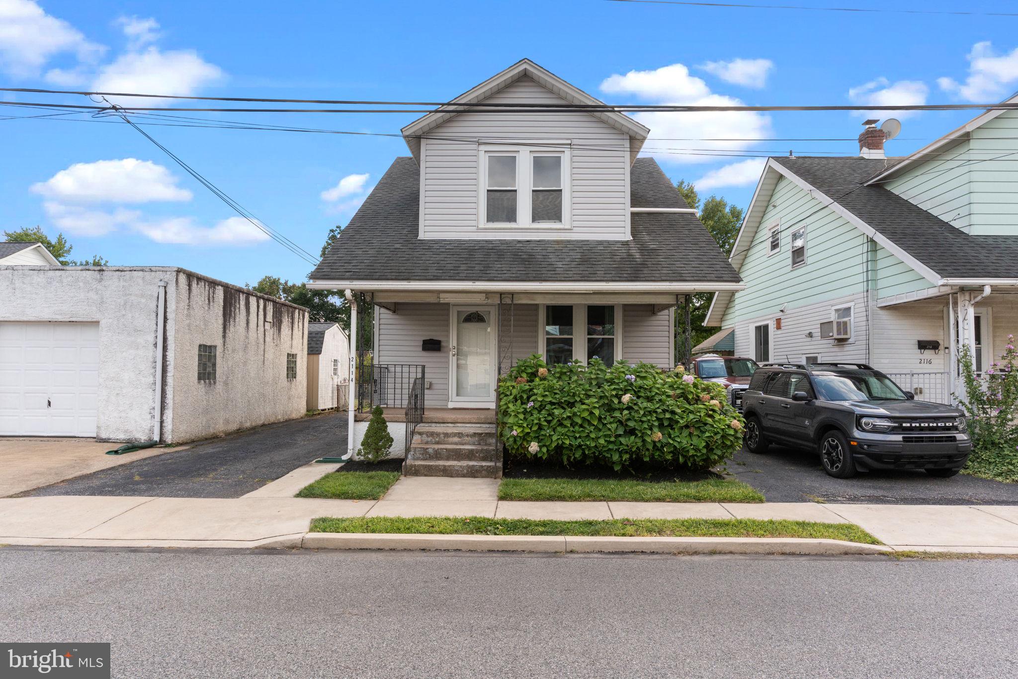 2114 Redwood Avenue Upper Chichester, PA 19061 - Photo 2 of 33 a front view of a house with a garden