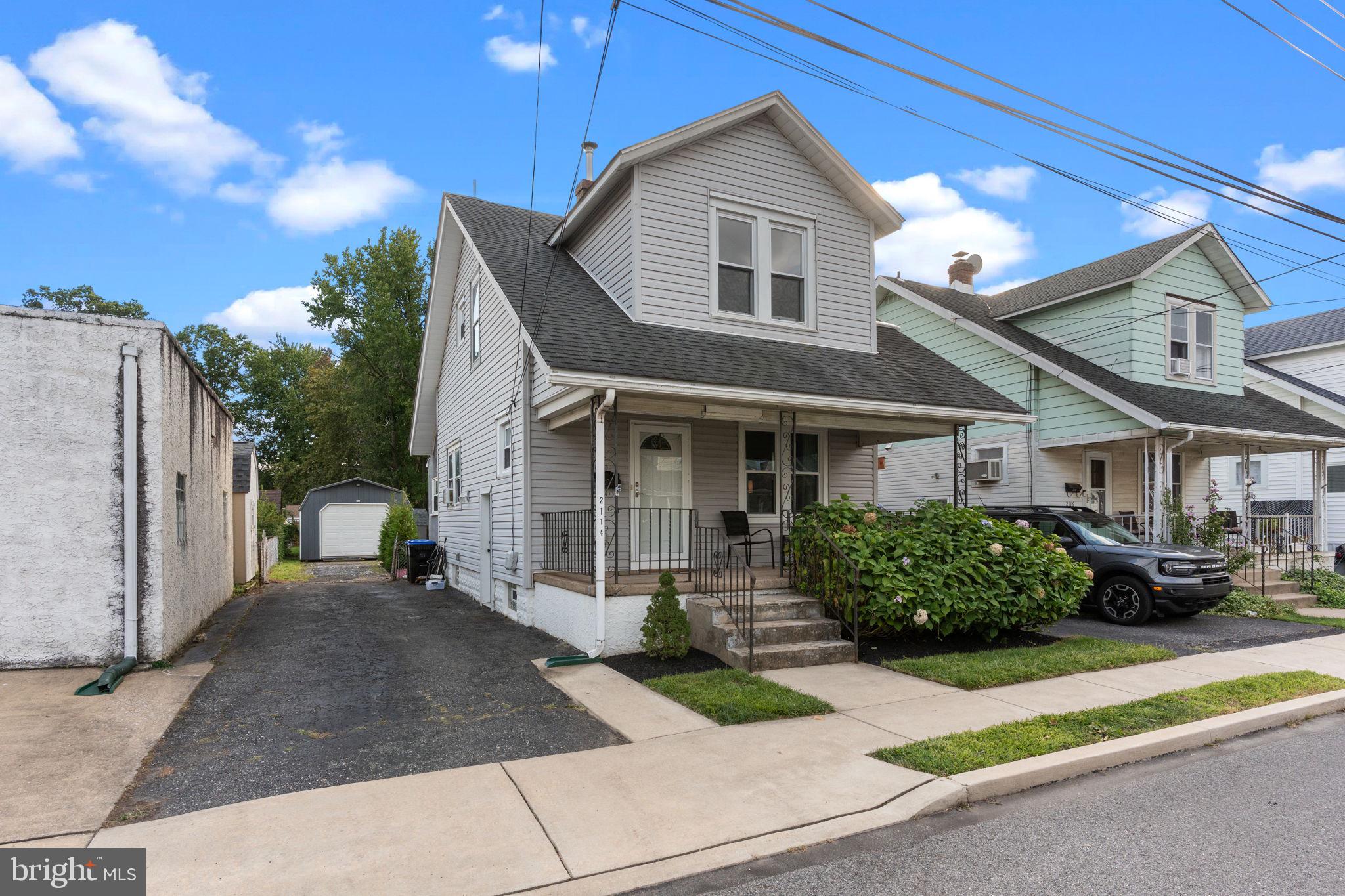 2114 Redwood Avenue Upper Chichester, PA 19061 - Photo 3 of 33 a front view of a house with a garden