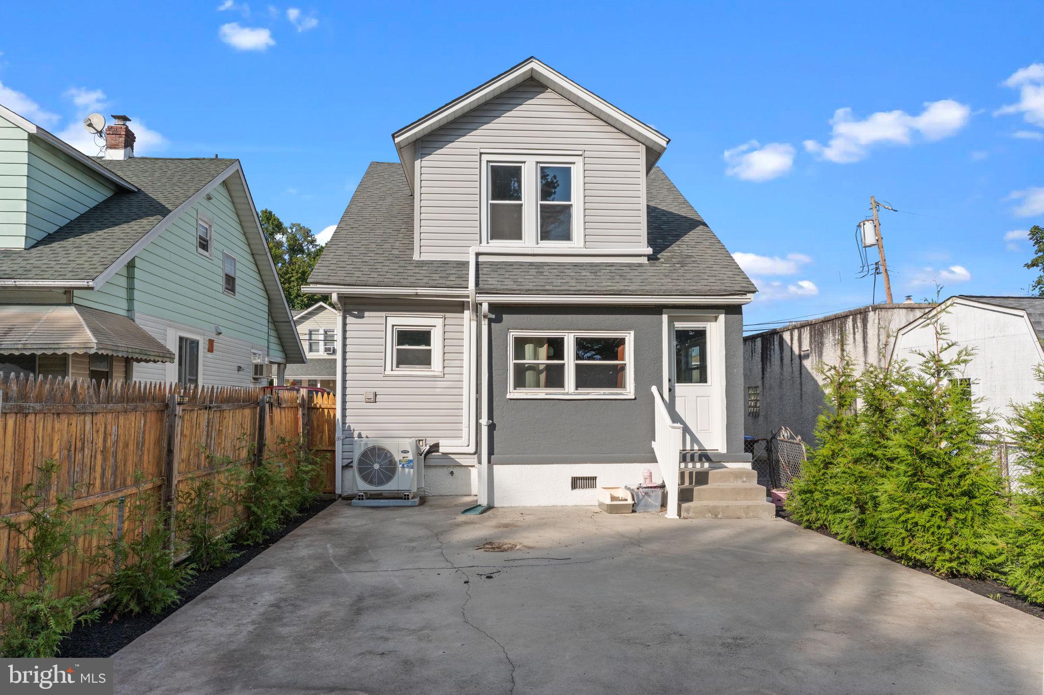2114 Redwood Avenue Upper Chichester, PA 19061 - Photo 31 of 33 a front view of a house with a yard and garage