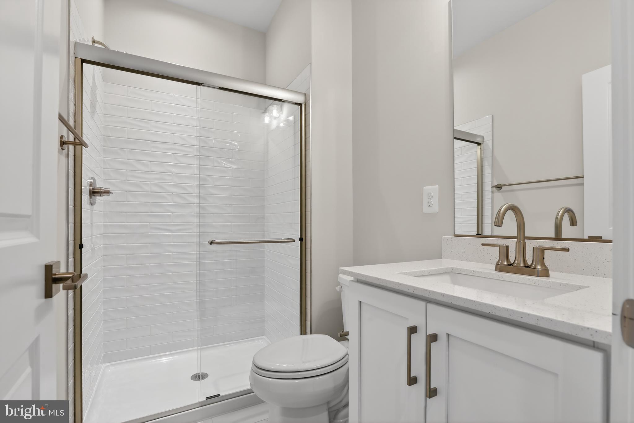 2717 Light Street Baltimore, MD 21230 - Photo 5 of 20 a bathroom with a shower sink vanity mirror and toilet