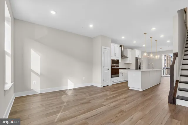 a view of kitchen with wooden floor and electronic appliances