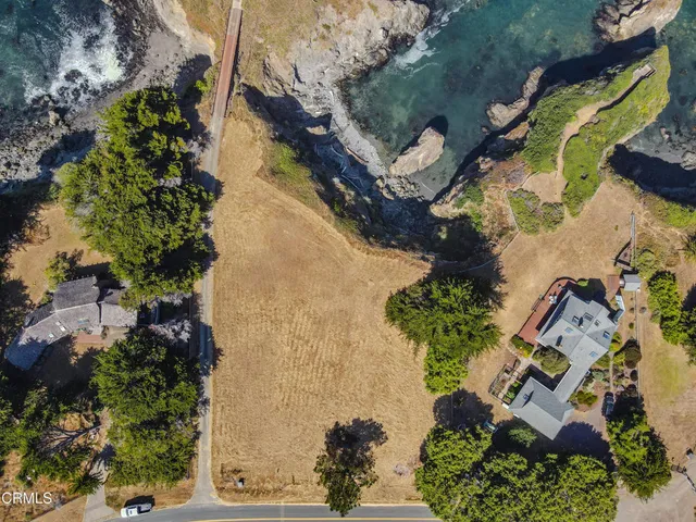 an aerial view of a house with a yard and garden