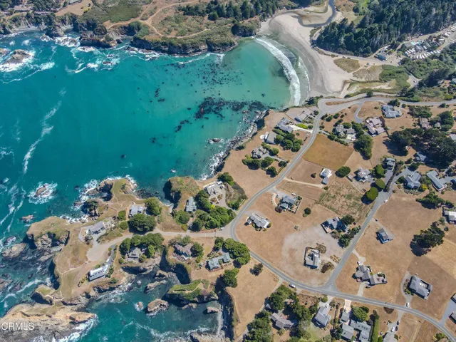 an aerial view of a house with a ocean view