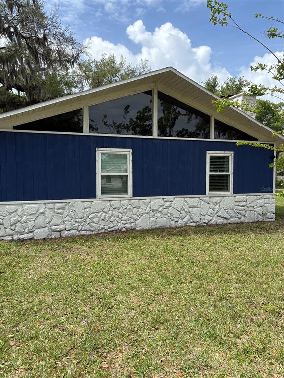 2203 Lime Tree Drive Edgewater, FL 32141 - Photo 2 of 10 a front view of a house with large trees