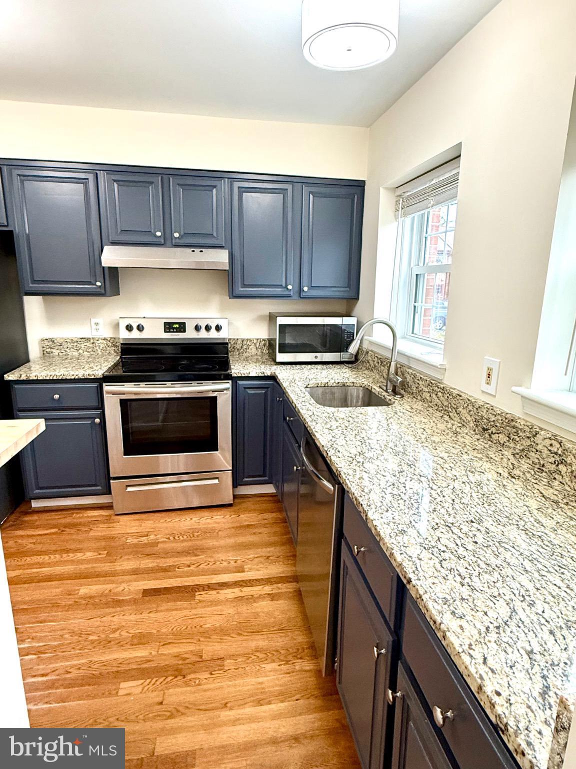 2196 Golf Course Drive Reston, VA 20191 - Photo 3 of 16 a kitchen with stainless steel appliances granite countertop a sink stove and oven