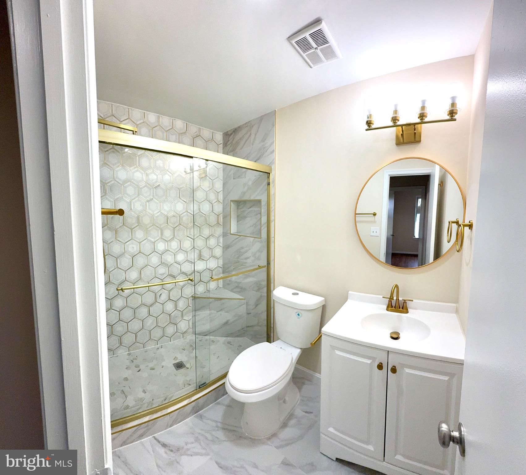 2196 Golf Course Drive Reston, VA 20191 - Photo 5 of 16 a bathroom with a toilet sink and a mirror
