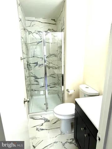 a bathroom with a toilet and a shower