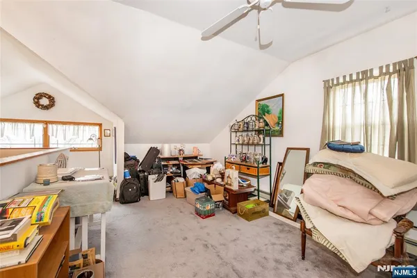 a view of a livingroom with furniture and a large window