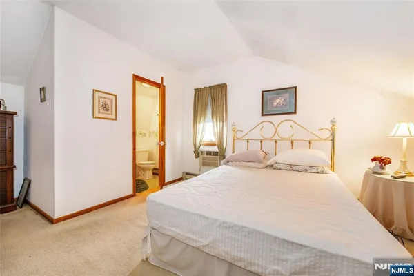 a bedroom with a bed and a tv