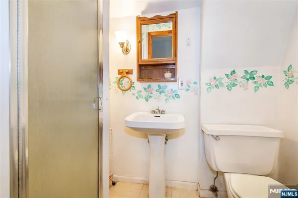a bathroom with a sink a toilet and mirror