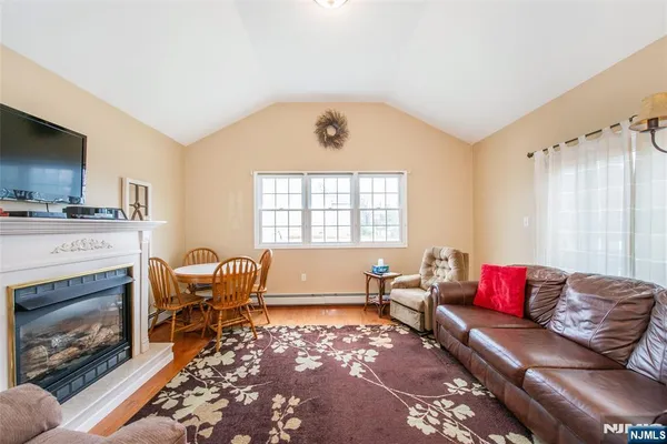 a living room with furniture fireplace and window