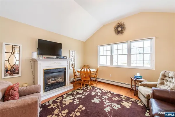 a living room with furniture a rug and a fireplace