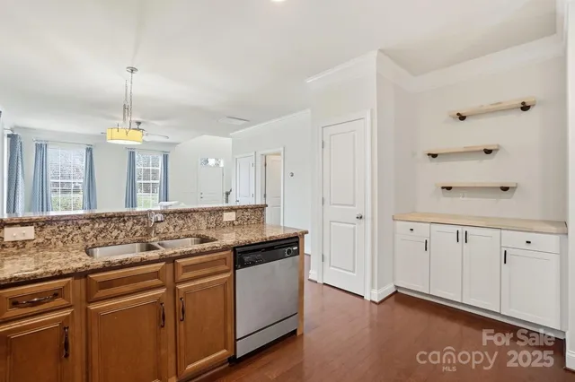a kitchen with stainless steel appliances a refrigerator and a stove top oven