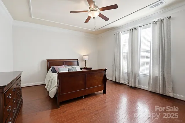 a bedroom with a large bed and a ceiling fan