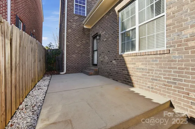 a view of wooden house with a wooden fence