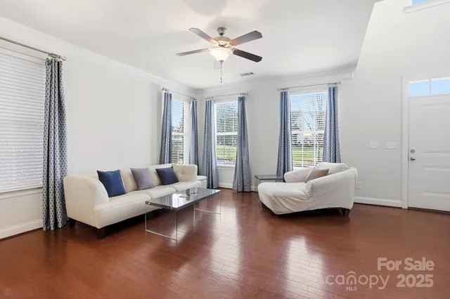 a living room with furniture and wooden floor