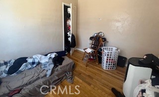 2238 Wood Street Merced, CA 95340 - Photo 8 of 15 a bedroom with a bed and wooden floor