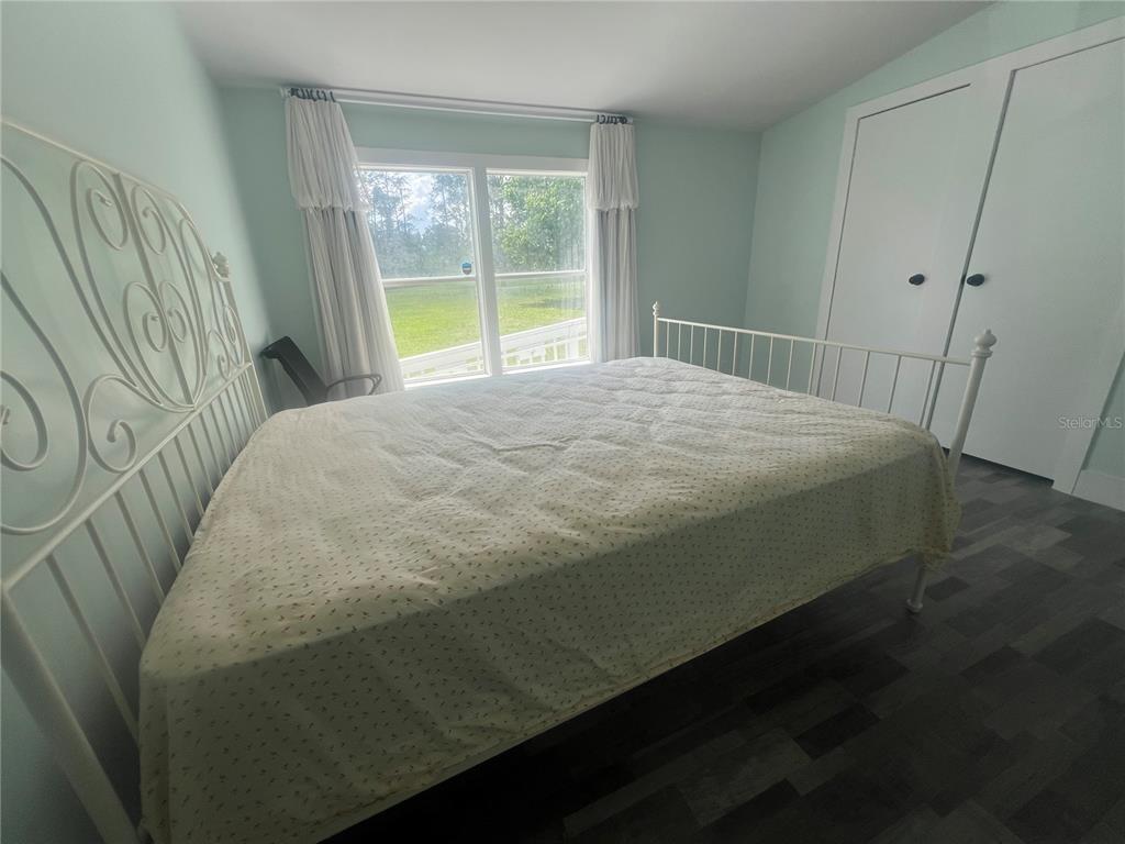 5855 Jack Brack Road St. Cloud, FL 34771 - Photo 73 of 86 a bed sitting in a bedroom next to a window