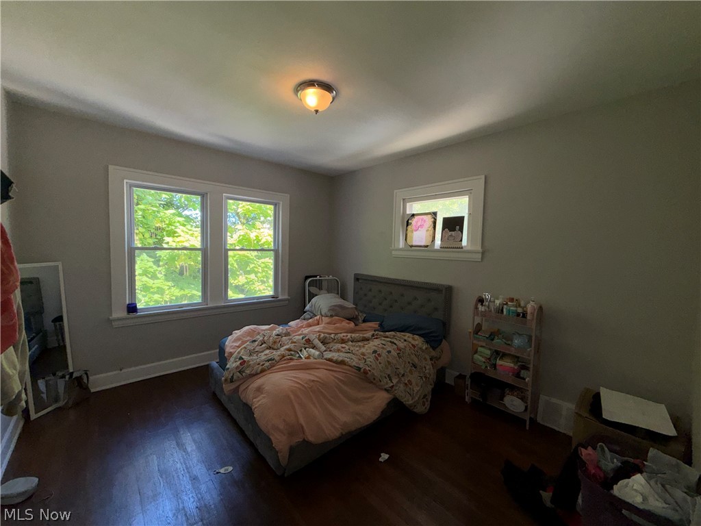 18017 Olympia Road Cleveland, OH 44112 - Photo 17 of 34 Wood-finish flooring with multiple windows and an overhead light fixture