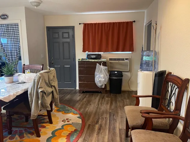 a kitchen with stainless steel appliances granite countertop dining table chairs and refrigerator