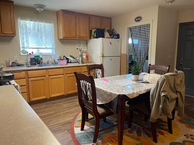 a living room with furniture a table and a chandelier