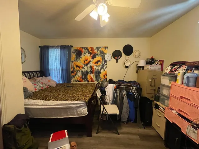 a bed sitting in a bedroom next to a window