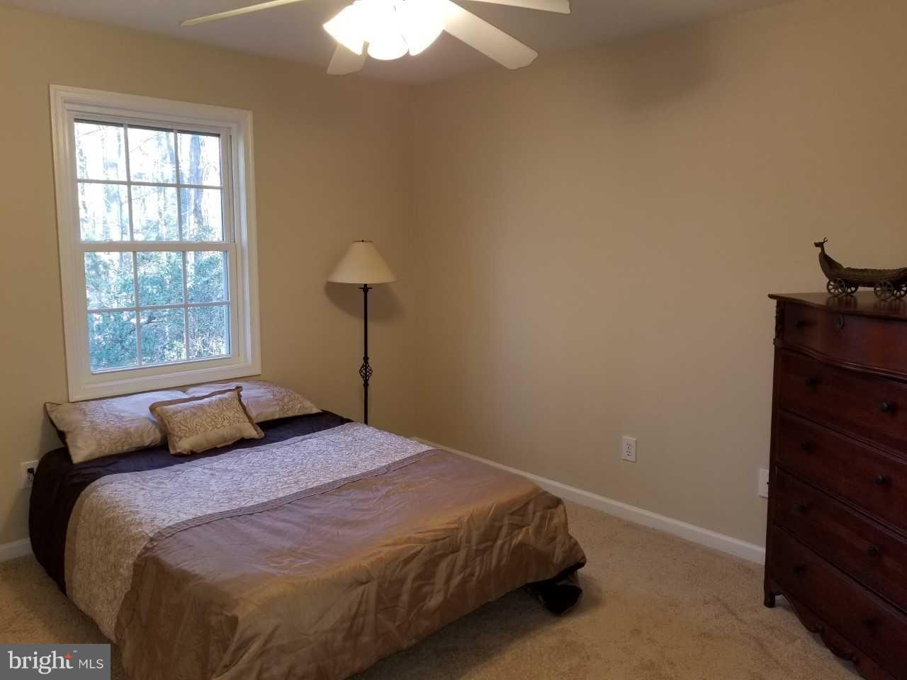328 12th Street Colonial Beach, VA 22443 - Photo 12 of 17 a bedroom with a bed and a window