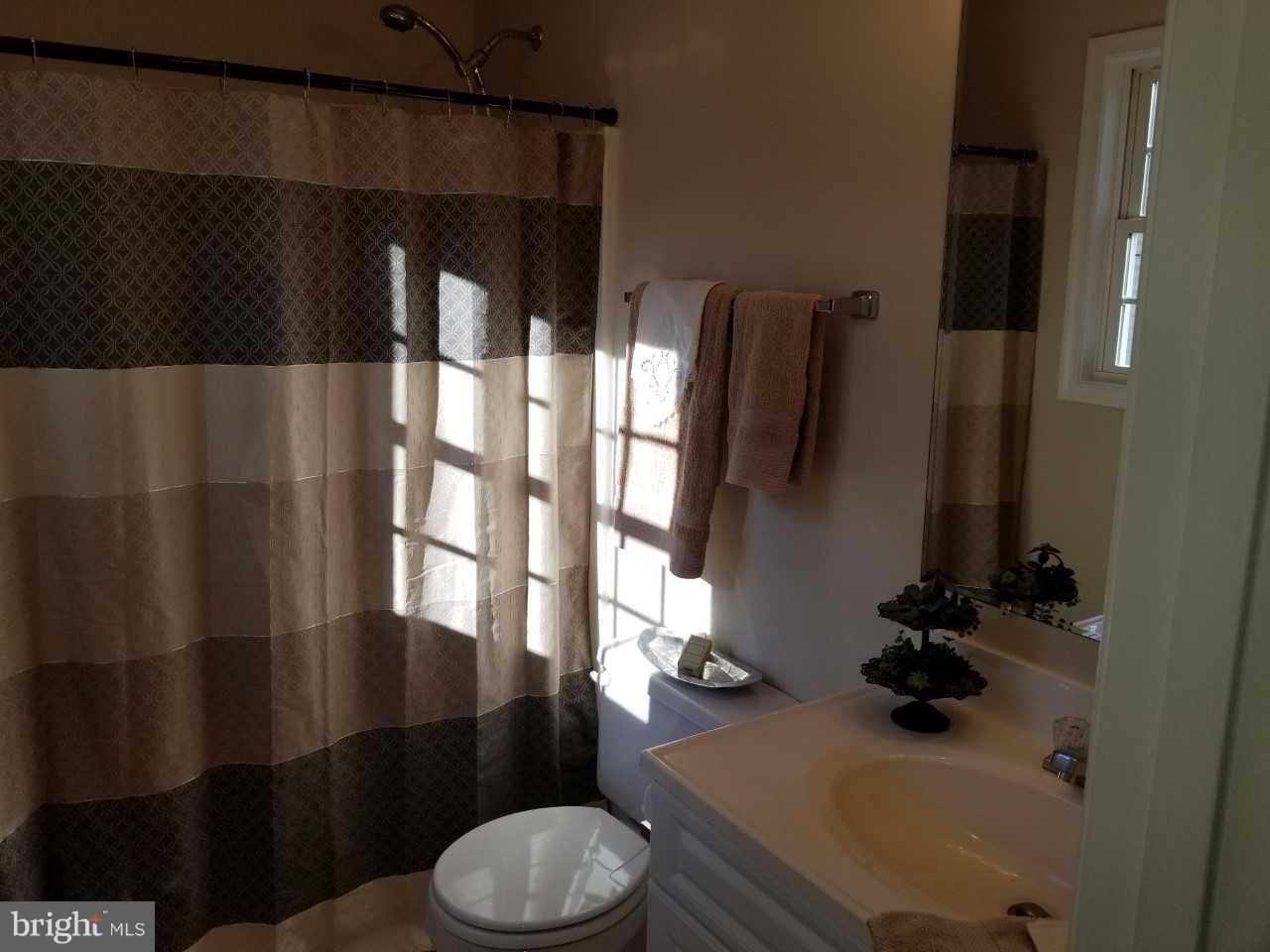 328 12th Street Colonial Beach, VA 22443 - Photo 13 of 17 a bathroom with a sink and a mirror