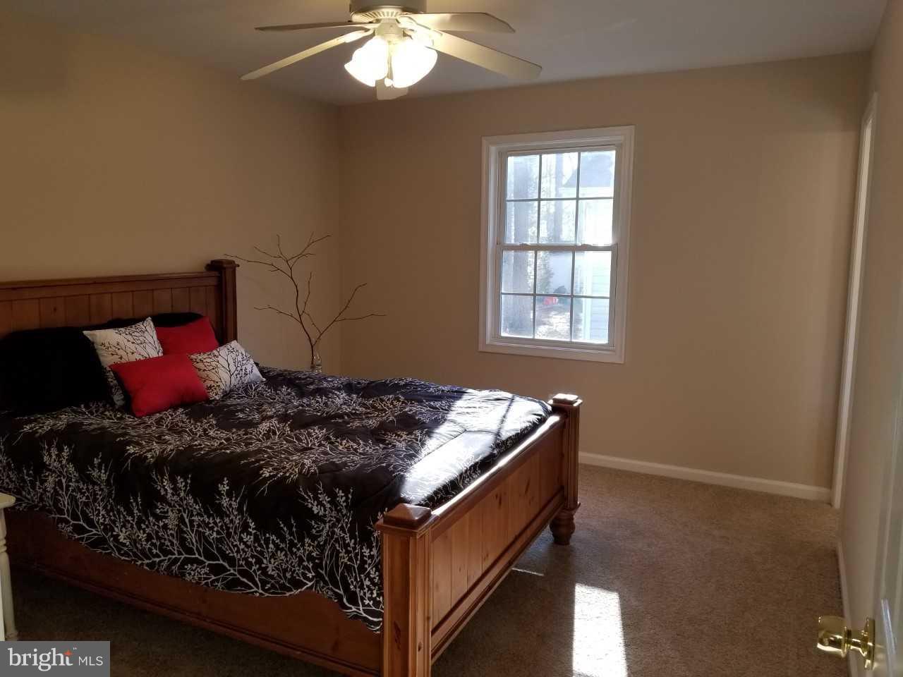 328 12th Street Colonial Beach, VA 22443 - Photo 14 of 17 a bed sitting in a bedroom next to a window