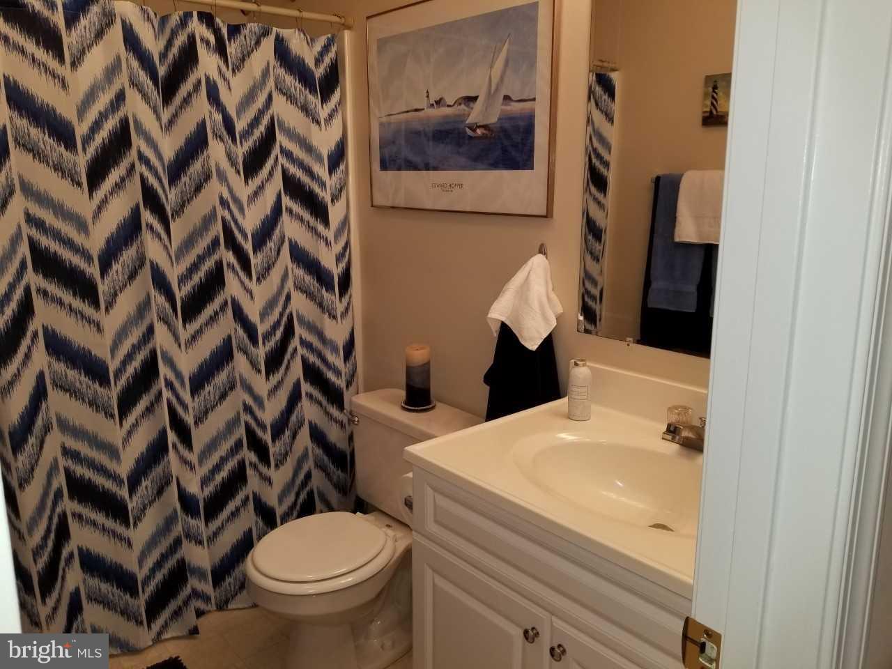 328 12th Street Colonial Beach, VA 22443 - Photo 15 of 17 a white toilet sitting next to a bathroom sink