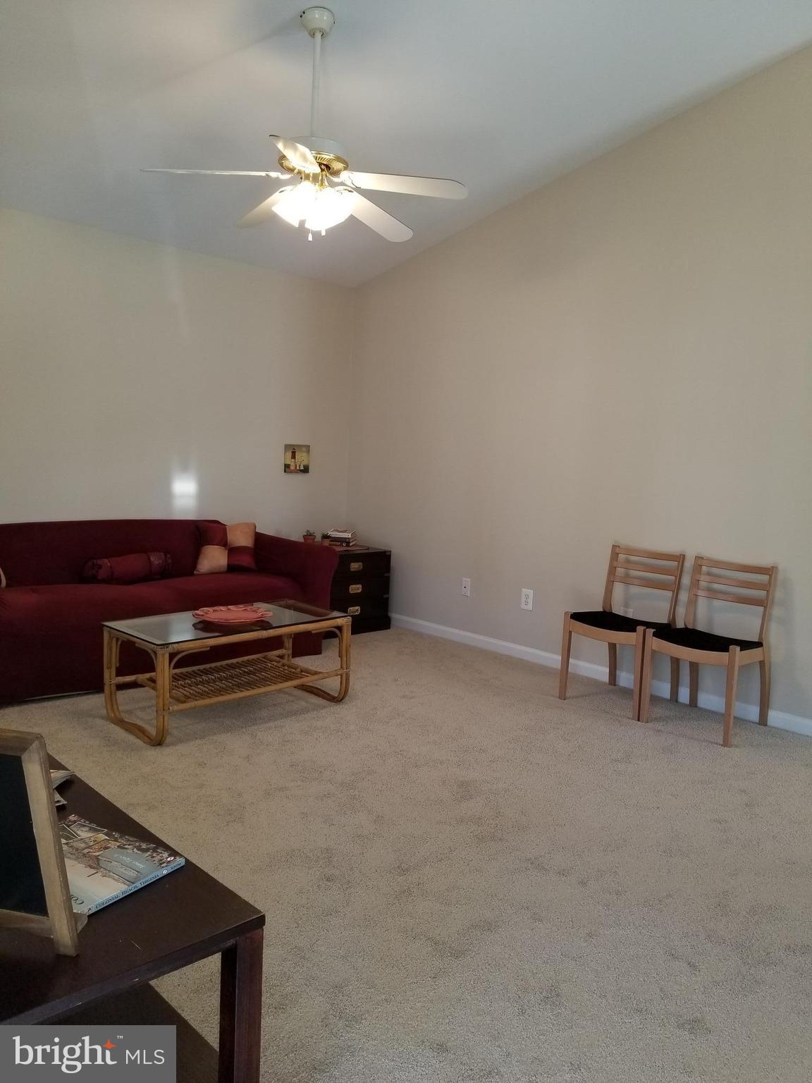 328 12th Street Colonial Beach, VA 22443 - Photo 5 of 17 a room with furniture and a mirror