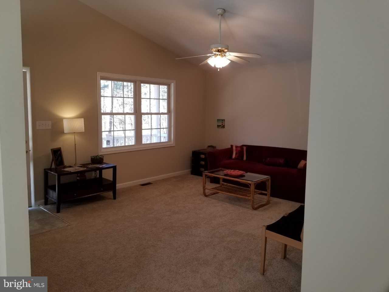 328 12th Street Colonial Beach, VA 22443 - Photo 6 of 17 a living room with furniture and a chandelier
