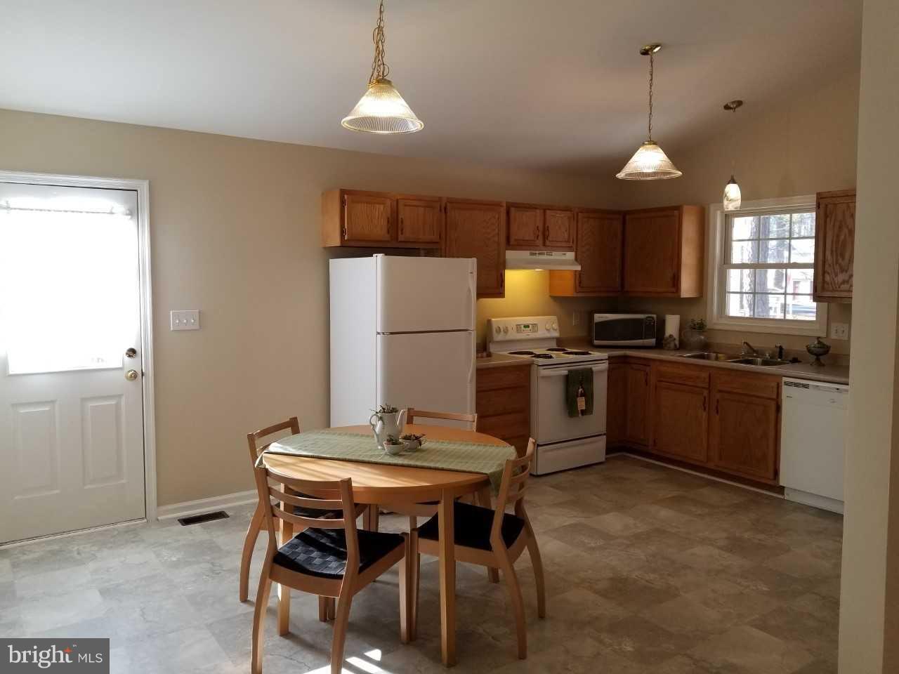 328 12th Street Colonial Beach, VA 22443 - Photo 10 of 17 a kitchen with cabinets a counter space and stainless steel appliances