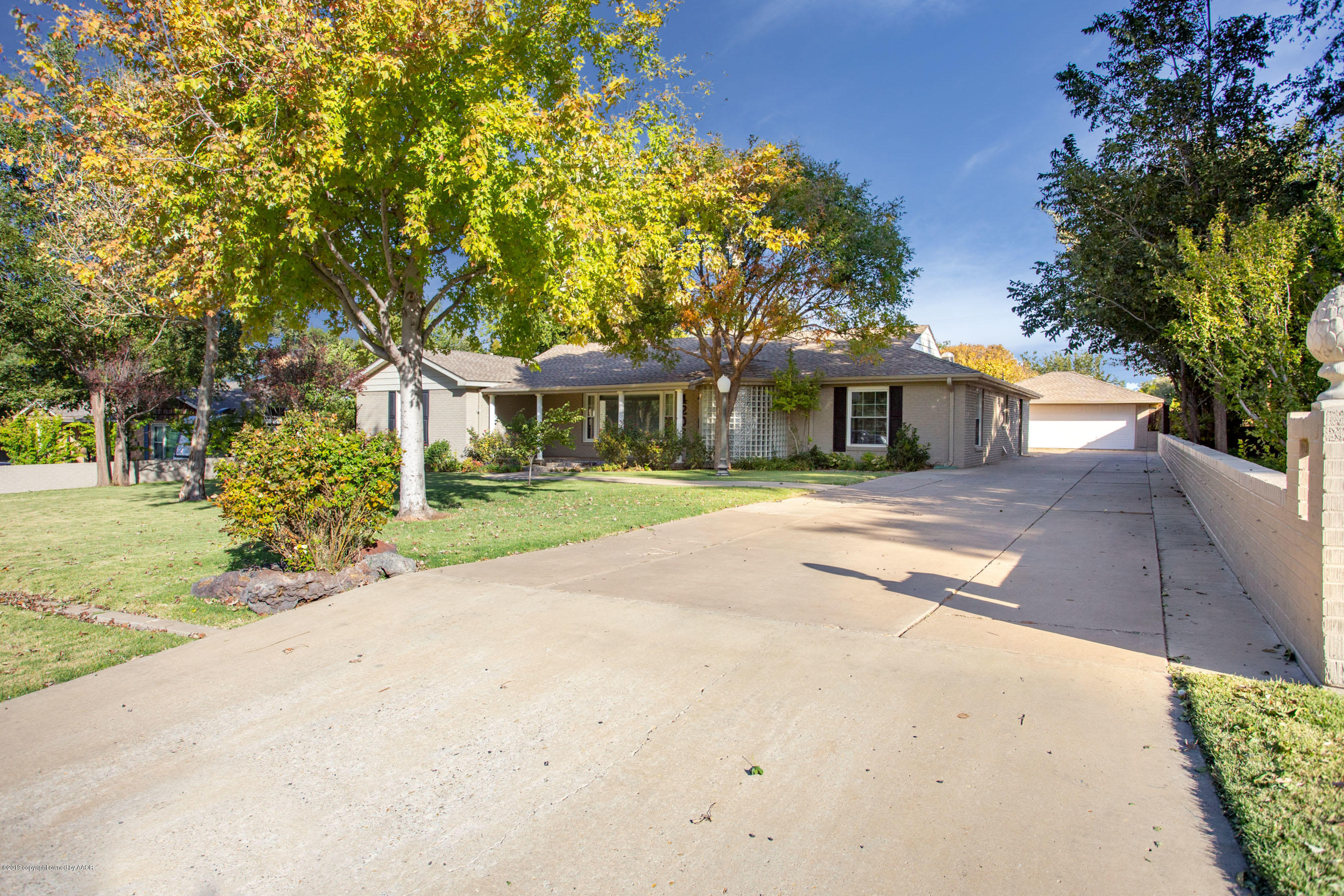 a view of a white house with a yard