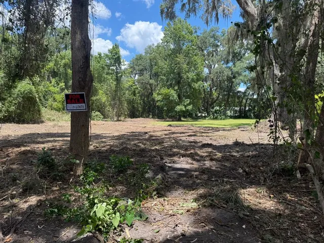 a street sign on a sidewalk next to a road