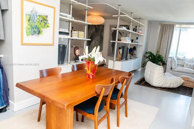a view of a dining room with furniture and a potted plant