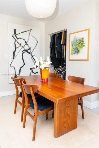 a room with table chairs and a flat screen tv