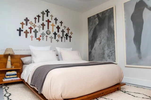 a bed sitting in a bedroom next to a window with a mirror