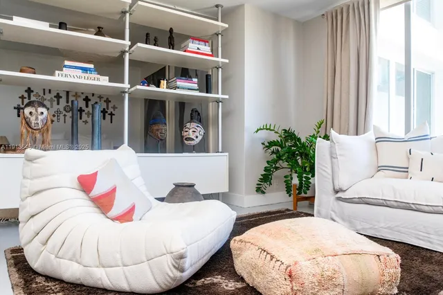 a living room with furniture and a potted plant