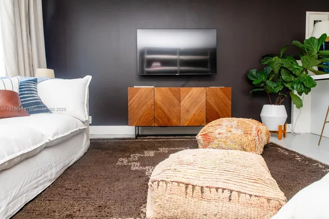 a bedroom with a bed lamp and a potted plant