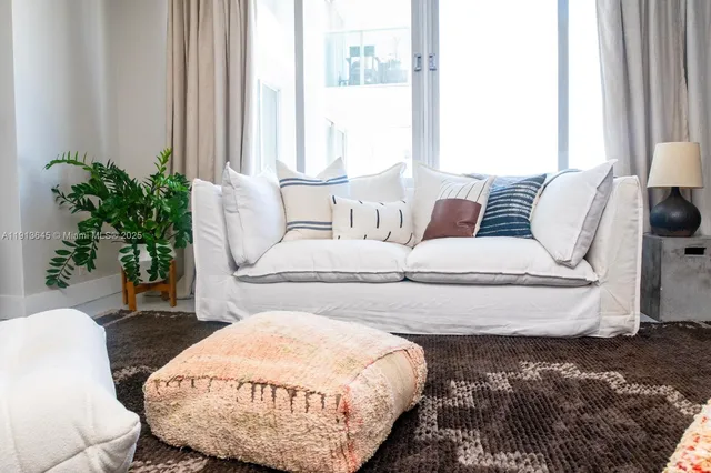 a living room with furniture and a potted plant