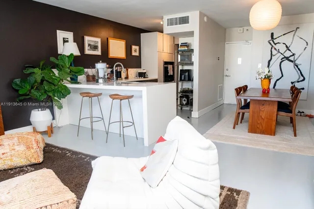 a living room filled with furniture and a potted plant