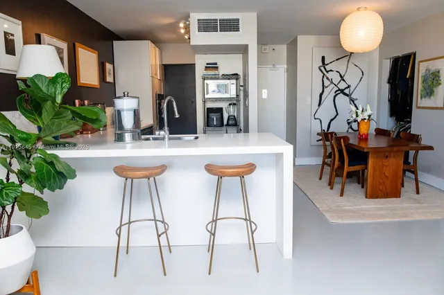 a view of a dining room with furniture and a potted plant