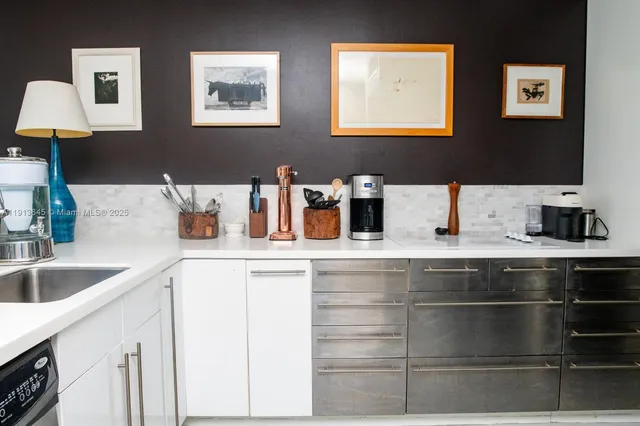 a kitchen with stainless steel appliances a sink and cabinets