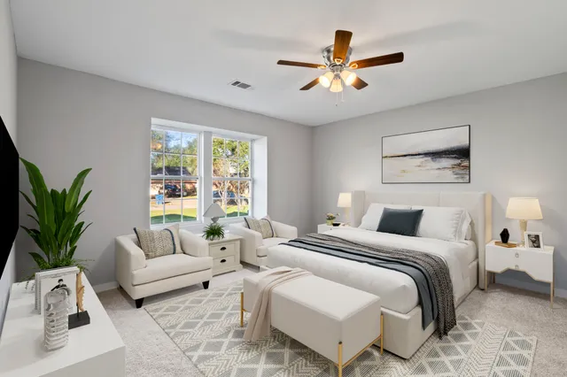 a bedroom with a large bed and a window