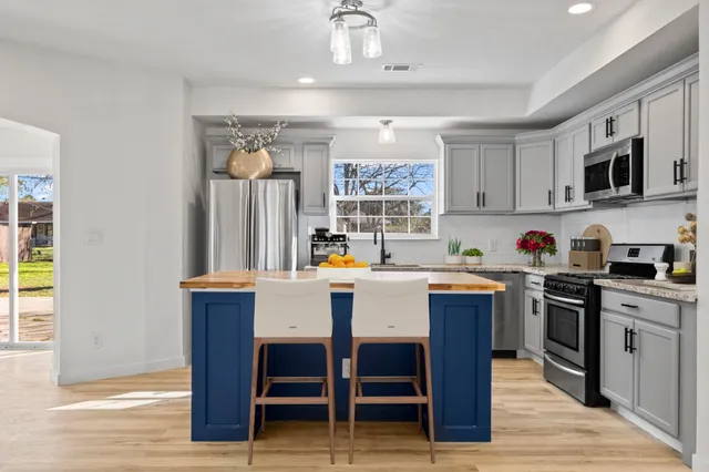 a kitchen with a sink appliances and cabinets
