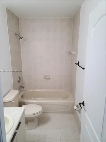 a bathroom with a toilet and a bath tub